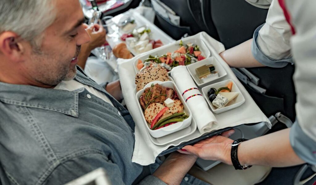 Passengers receiving gastronomic food on a plane